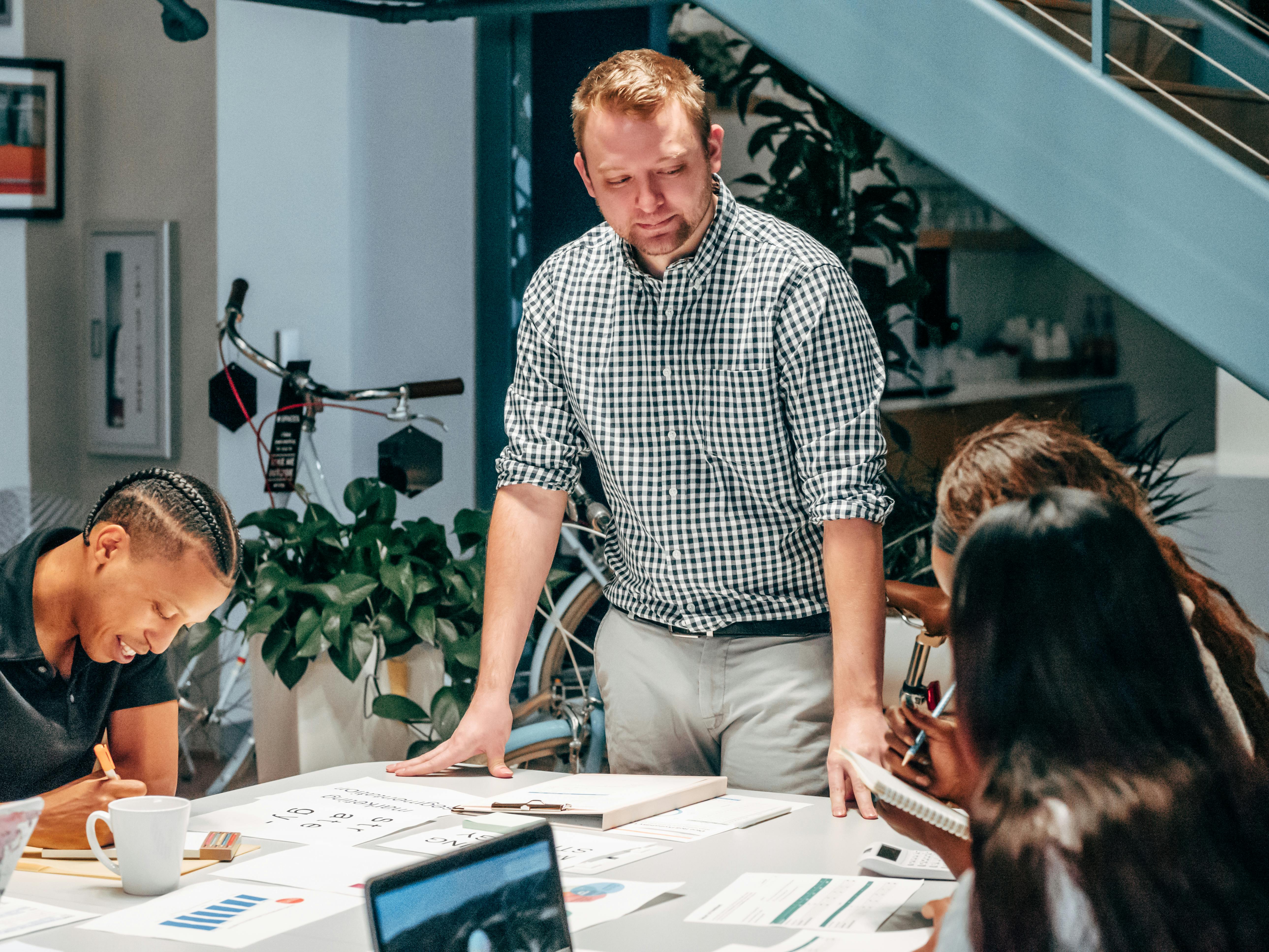 Team gathered around a table discussing work